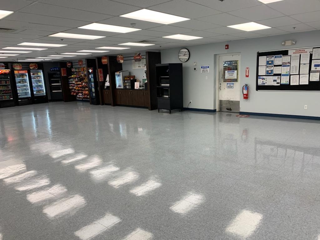Commercial break room floor after stripping and waxing — gleaming, polished VCT tile