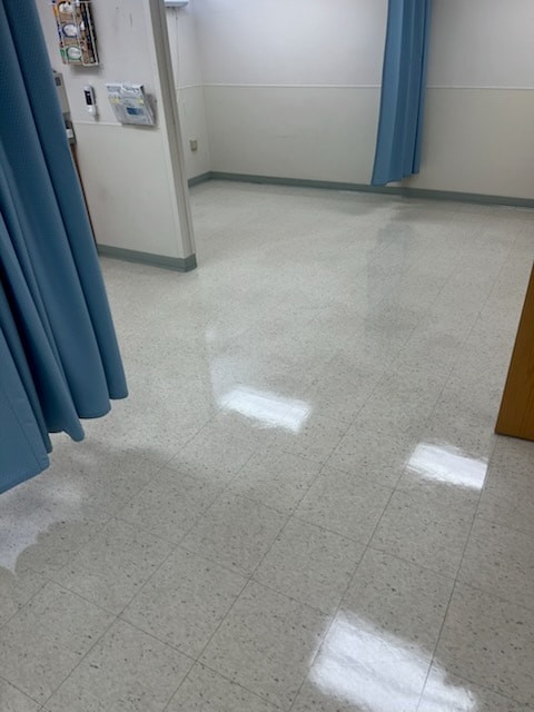 Medical exam room floor after commercial floor restoration — mirror-like polished tile