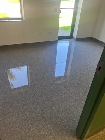 Commercial facility floor after stripping and waxing — high-gloss polished finish