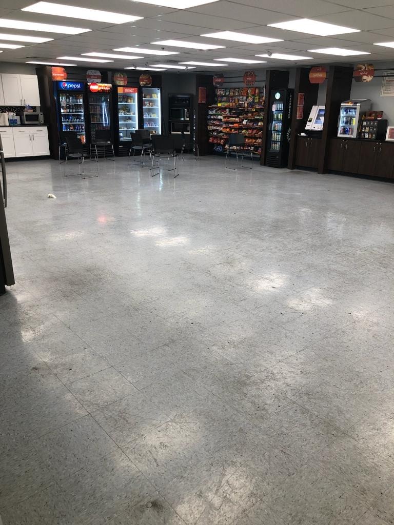 Commercial break room floor before cleaning — worn, dull VCT tile